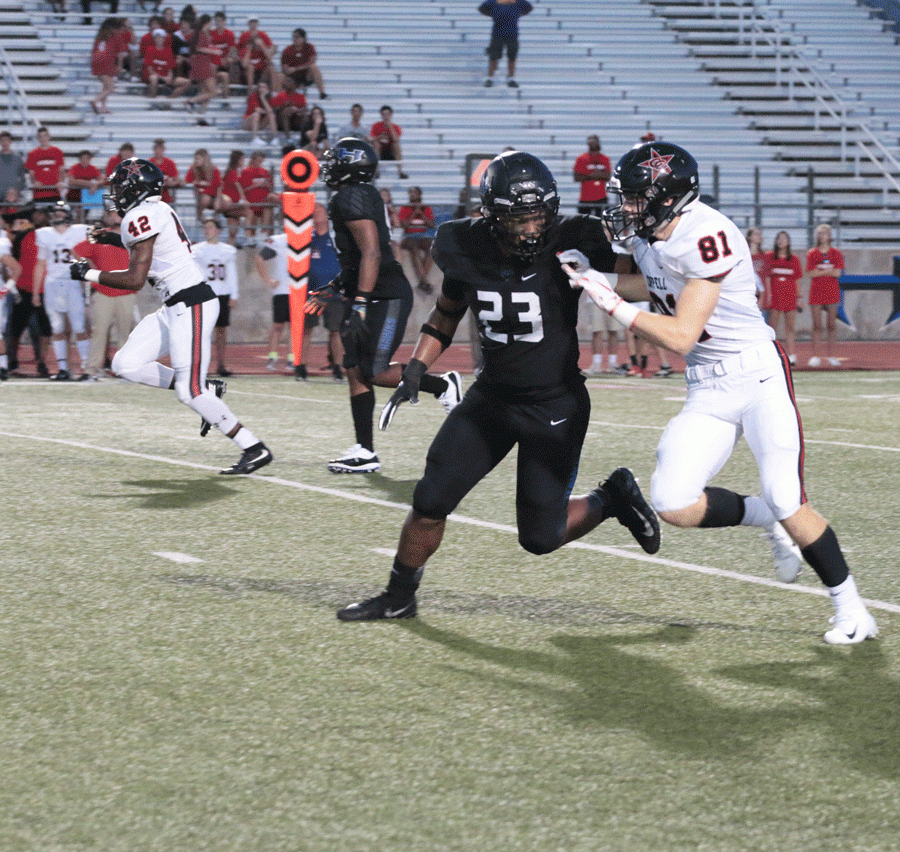 Junior Darius Snow blocks a Coppell player from advancing. 