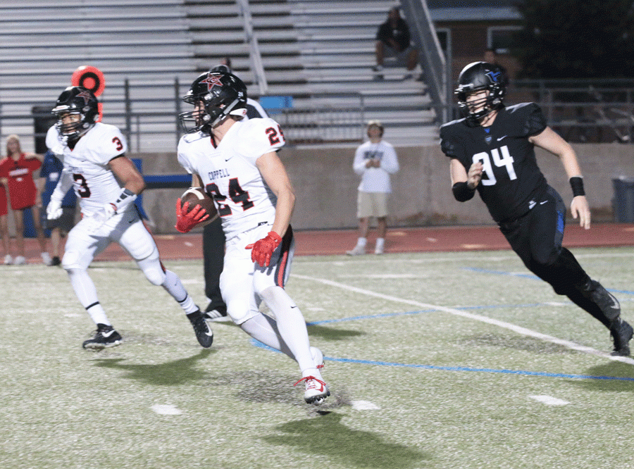 Senior defensive end Cole Phillips attempts to stop a Coppell player from advancing with the ball. 
