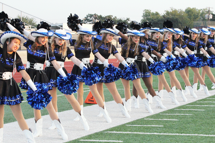 The Silver Wings drill team lines up to welcome the football players onto the field. 