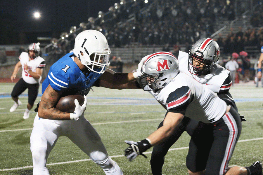 Senior wide receiver Trejan Bridges grapples with a Marcus player in order to keep possession of the ball. 