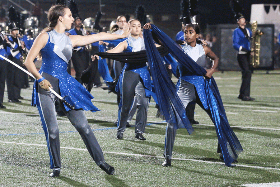 Senior color guard captain Courtney Burgess and sophomore Liya Siby perform selections from the Hebron Bands competition piece, Endeavor. 