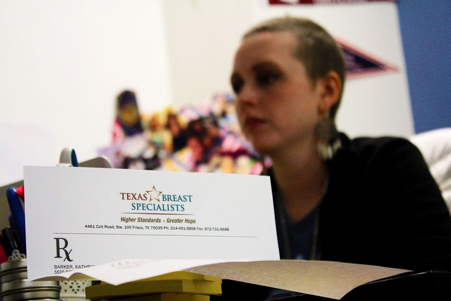 English teacher Kathryn Barker works at her desk as her return to work letter is displayed in front of her.