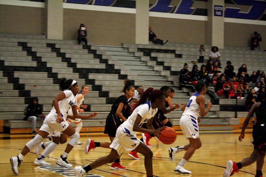 Sophomore Demauria Miles dribbles to the basket.