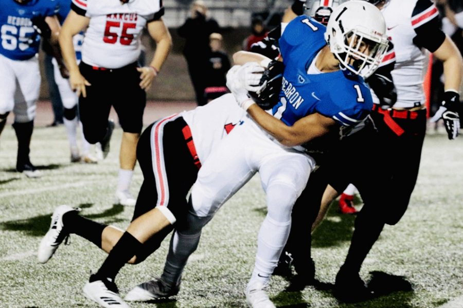 Senior wide receiver Trejan Bridges dodges Marcus players in order to run the ball up the field in a game on Oct. 12.