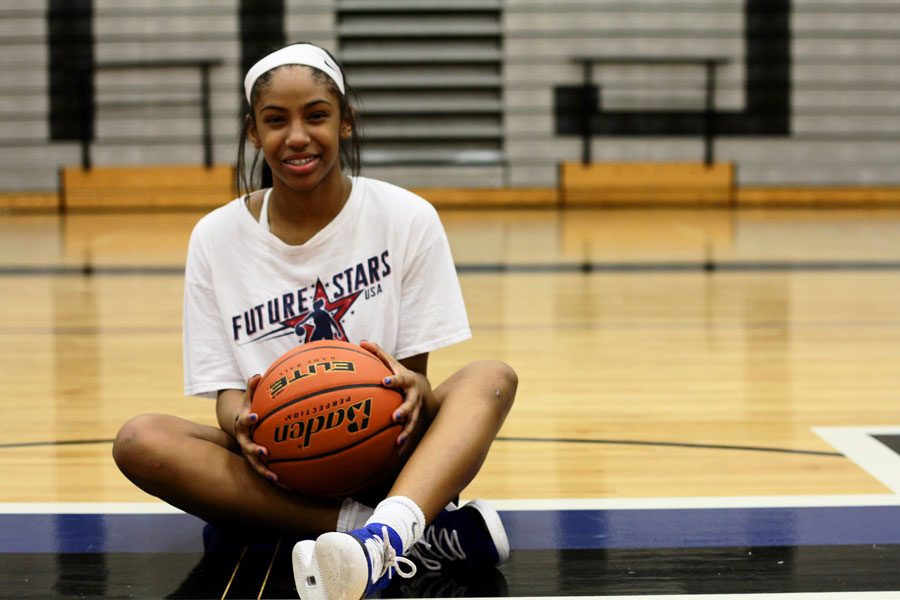 Freshman Cammie McKinney poses on the super H in the gym. McKinney is the only freshman on the varsity girls basketball team. 