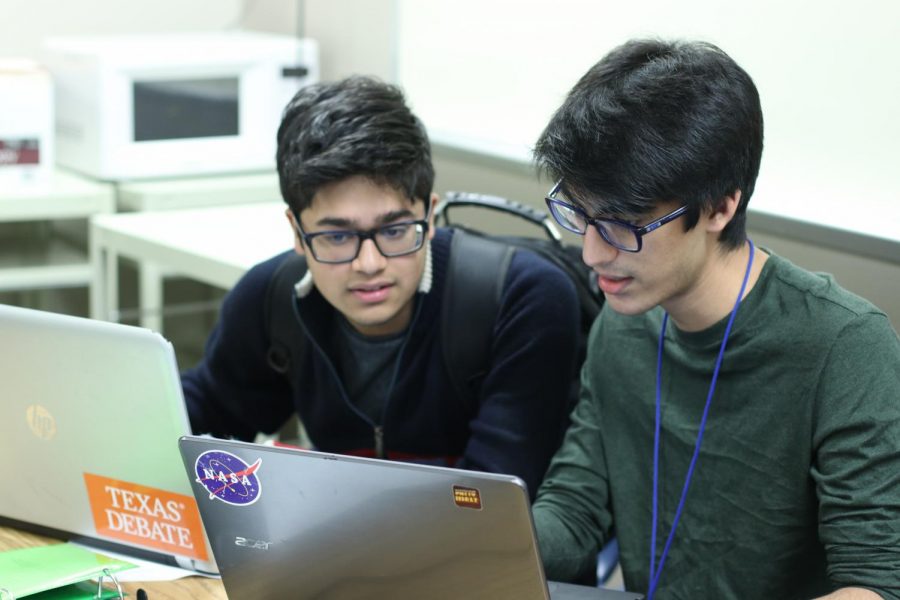 Juniors Krish Patel and Sameer Haq discuss debate tactics.