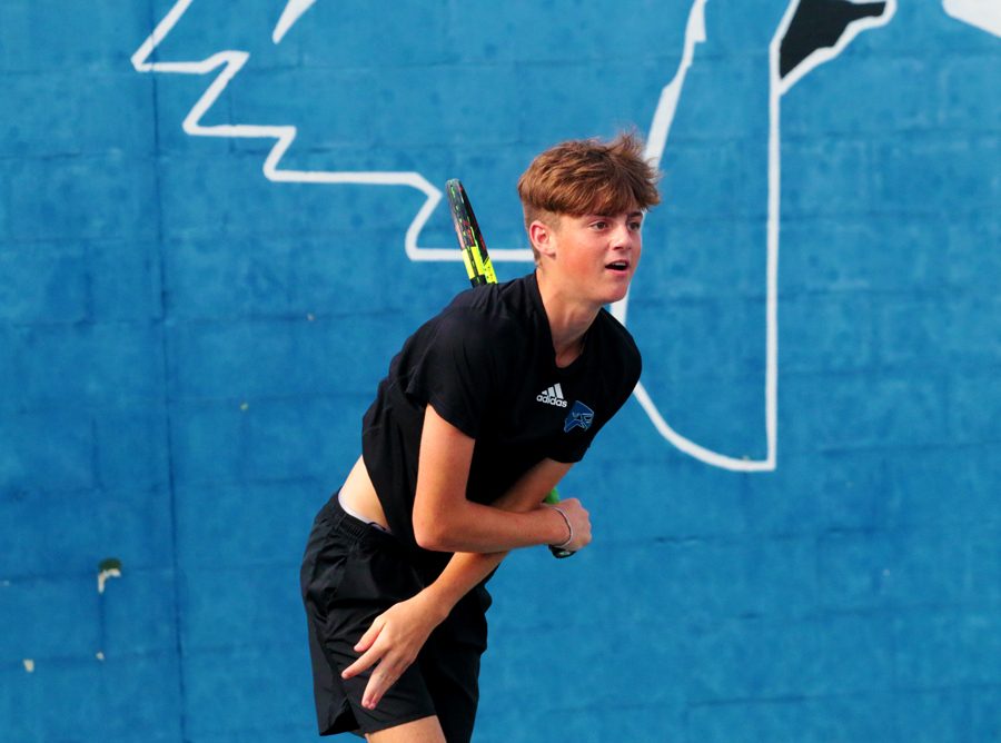 Freshman Dylan Bogan serves during a doubles match. The tennis team will play the Colony August 23.