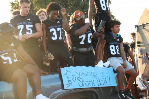 The varsity football team stands on their float during the Homecoming Parade Sept. 25. The team will be going against Irving Nimitz Vikings on Sept. 27 at the homecoming game. 