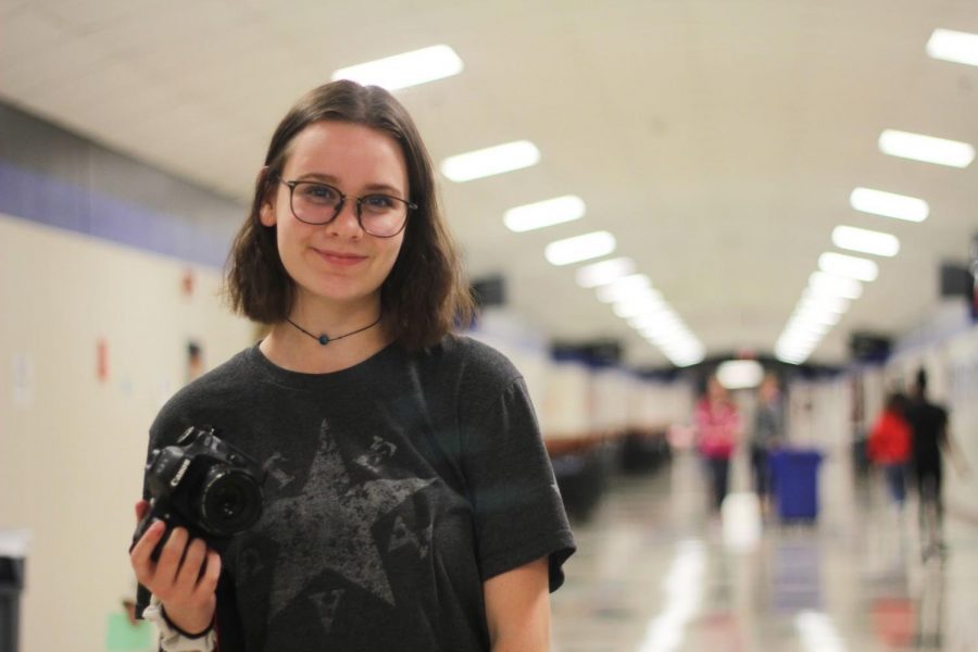 Junior Heather Nixon holds the camera she uses in yearbook. Nixon takes pictures not only for the yearbook, but also for paid photo shoots she does outside of school. “Last year I created an Instagram just for my photography and a website for my portfolio which now also has [photography] services too on it,” Nixon said. (https://heathernphoto.wixsite.com/photo)