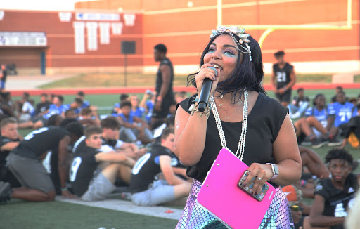 Student Council sponsor Jennifer Russell introduces the senior football moms for their dance at the homecoming community pep rally on Sept. 25. They performed a dance to songs like “Old Town Road” and many more with their sons on the football field at the homecoming parade.