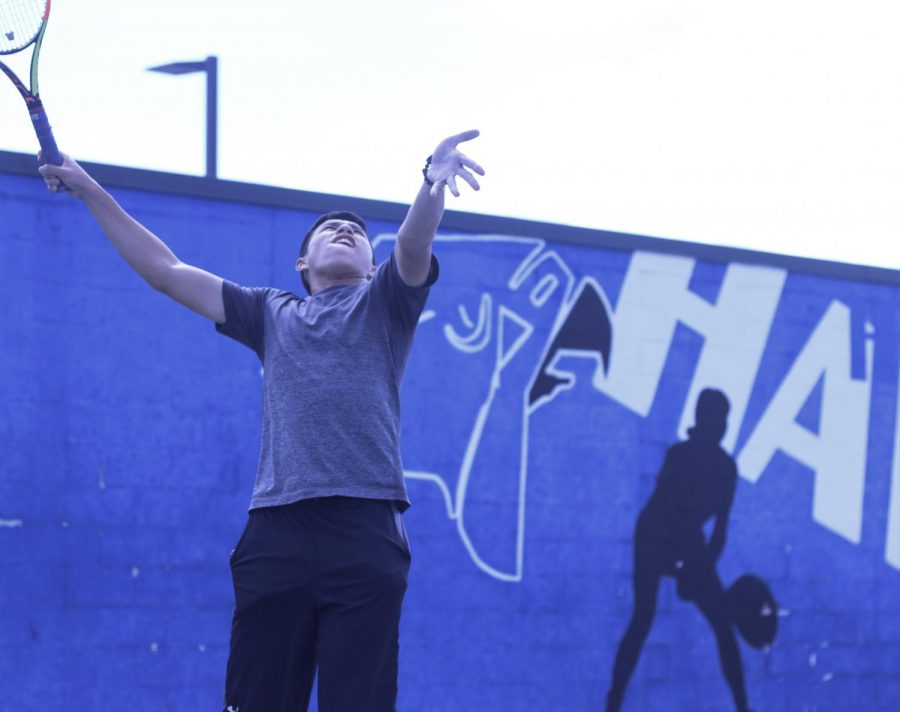 Senior Zachary Grasty practices his serves during 4th period. The tennis team typically performs better in the spring than the doubles-heavy fall semester, but this year theyre looking to go far in playoffs after beating Marcus and Flower Mound.