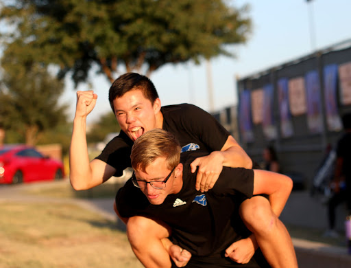 Senior Zach Grasty and junior Ben Grider celebrate their wins against Lewisville. This is Grasty’s fourth year on varsity, and Grider’s third year on the team.
