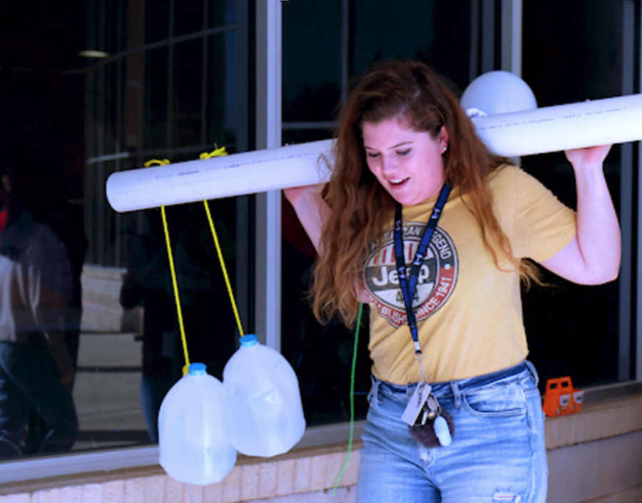 Junior Sydney Brinkley carries 45 pounds of water on her shoulders as she walks outside in front of the cafeteria. Brinkley joined UNICEF after hearing about the club from co-president Chu. “UNICEF at Hebron isn’t a big club, but the impact UNICEF has on children around the world is,” Brinkley said. “Every donation, whether big or small, makes an impact on someone else’s life.”