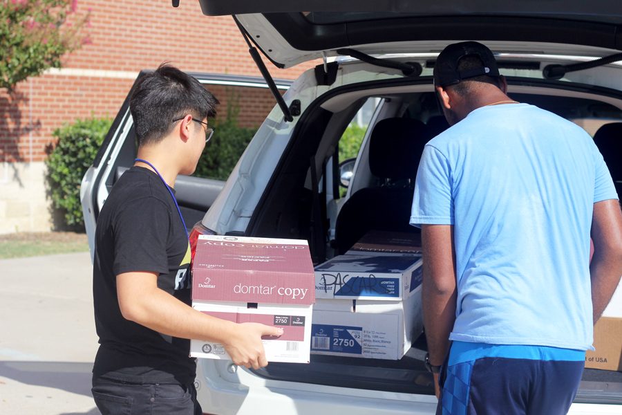 Seniors+Phillip+Ng+and+Allan+Jacob+load+boxes+filled+with+donations+into+Allans+car.+After+loading+the+supplies+into+the+car%2C+the+seniors+went+shopping+with+the+remaining+money.+