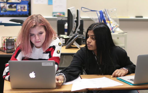 Sophomores Maddison Smith and Saba Ali look over cases for their debate topic. Debate has practice every Tuesday after school from 4:00 p.m to 6:00 p.m. “I hope to become better at managing my time better during rounds and maybe being more exaggerated when talking and giving speeches,” Ali said.
