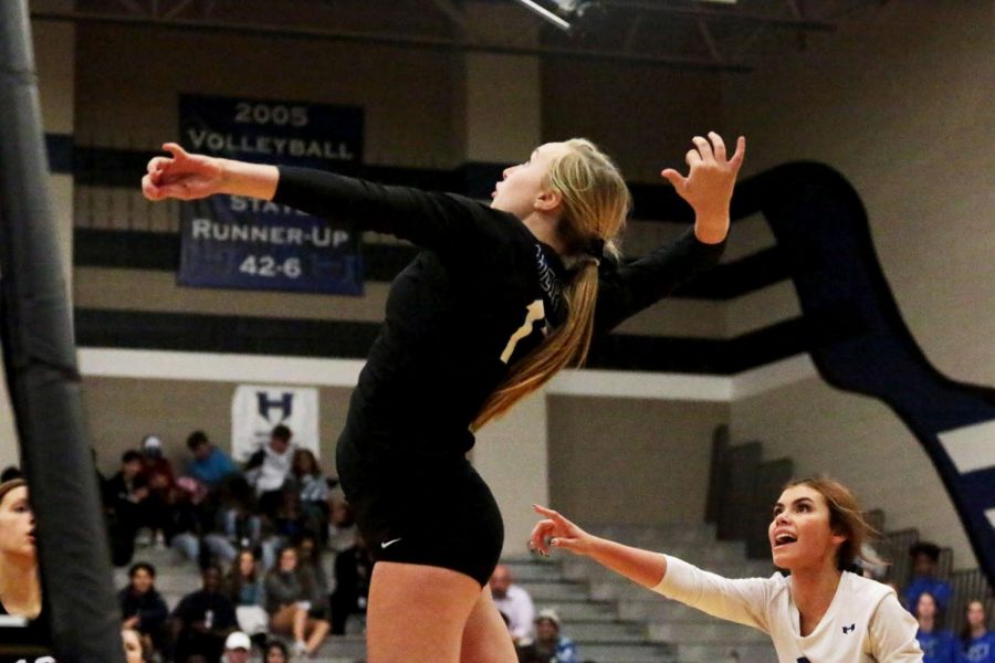 Sophomore Payton Merrill spikes the ball. Merrill was put in the game during the last match.