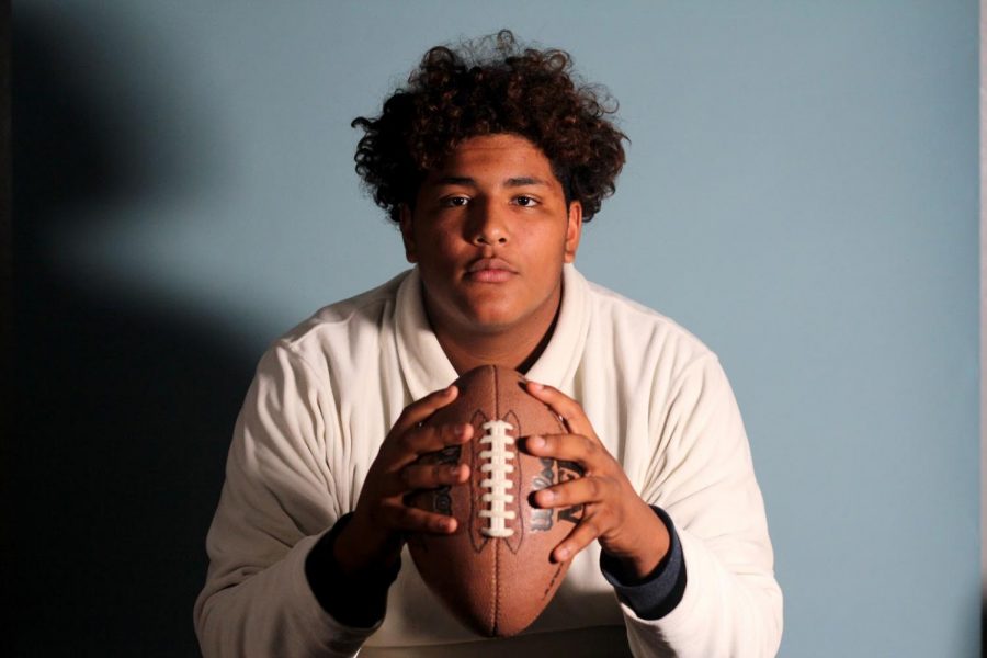 Junior Dakota Newfield holds a football and poses for a photo. He first developed an interest in football during sixth grade. “When I found out that my dad played I really started to develop an interest, especially when I started watching the NFL.” Newfield said.
