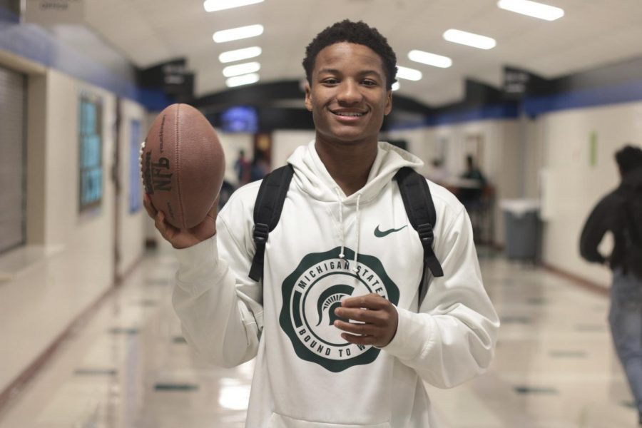 Senior Darius Snow poses with a football while wearing Michigan State merchandise. Snow will be graduating early on Jan. 2nd.  