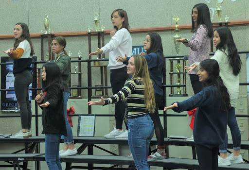 Choir rehearses their choreography for one of their songs, “Mr. Santa,” on Dec. 2 during third period. “I’m excited to sing with the elementary and middle school kids,” sophomore Saara Sherali said. “It’s always fun to see how they sound and it’s a great way to encourage them to stay in choir.” 