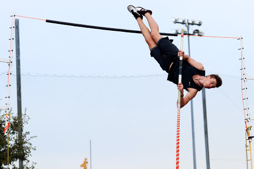 Junior Lucas Huckeba jumps 13 feet while pole vaulting. He practices almost every day during fourth period and after school. “To be a good pole vaulter, you need to be a good athlete,” pole vault coach David Brown said. “It always helps to have good speed, and the main thing is that you’re not scared of getting up on a tall stick 16 feet in the air.”

