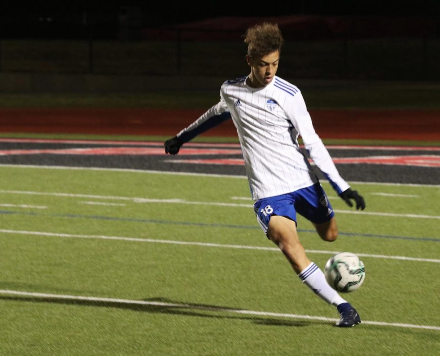 Junior Cayden Casburn clears the ball to deny the Cowboys a chance to score. Casburn is a defender and this is his first full season on the varsity team. 
