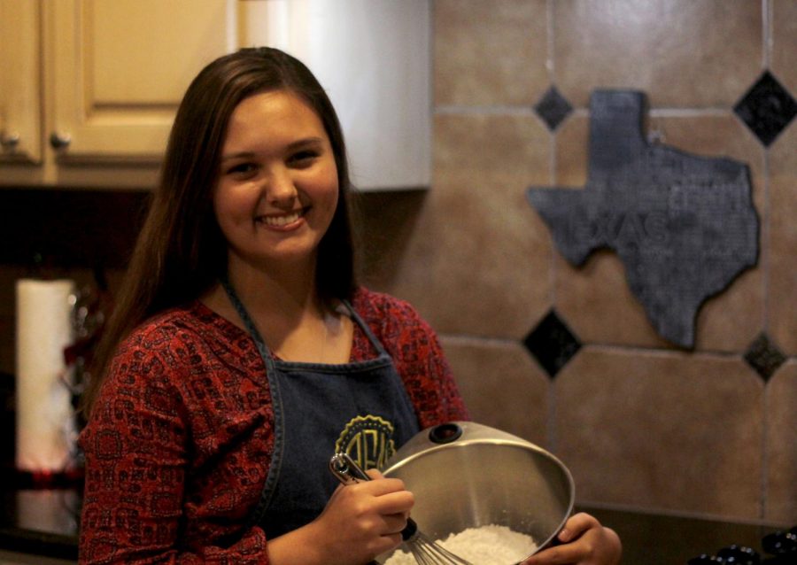 Sophomore Audri Fleming smiles as she bakes cookies for a customer. Fleming has been baking since eighth grade and plans to attend the Culinary Institute of America after high school. 
