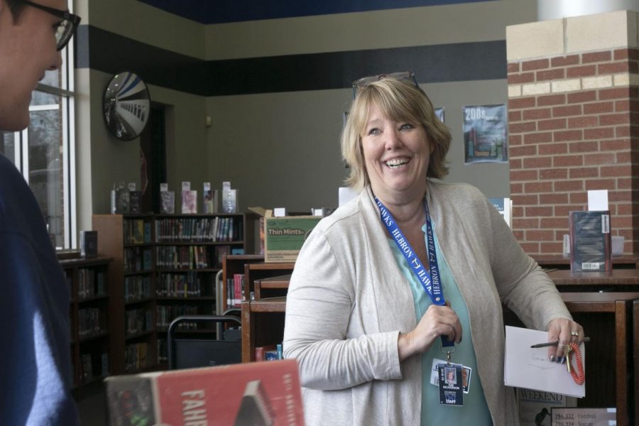 English teacher Kimberly Nickerson aids a student in finding a book for Sustained Silent Reading (SSR). The students have SSR time almost everyday to sharpen their understanding and reading skills.
