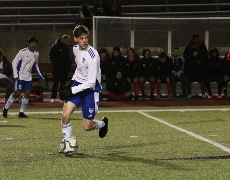 Senior Grant Bartley looks to pass the ball to a teammate in the Jan. 28 match against Coppell. Varsity won the game 3-1, but will be playing the Cowboys again Feb. 25 at home. 