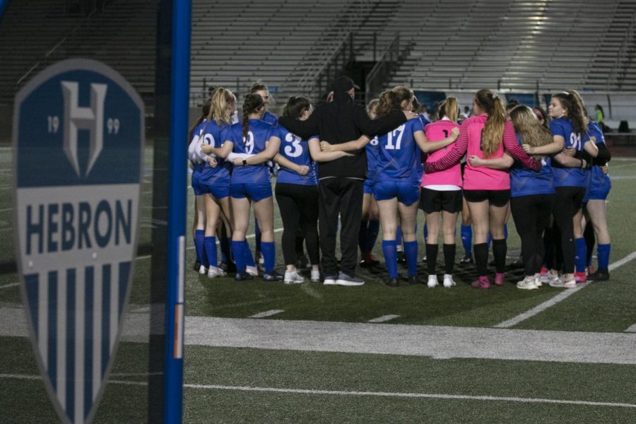 Varsity gathers in a huddle before the kick off. It is tradition for someone to lead the team in prayer before the match, and after the prayer, the girls yell a chant that starts, “Matthew, Mark Luke and John” and blesses the game. 