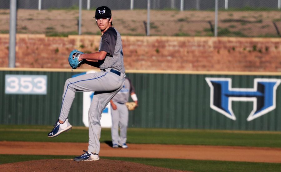 Senior Tre Henry is pitching the ball against Prosper at Hebron. Pitching is one of the teams strengths this year, according to Stone.