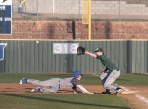 Junior Trent McCown dives back into first after the pitcher tries to pick him off at the Hebron vs. Prosper scrimmage on February 24. Varsity practices during fourth period.