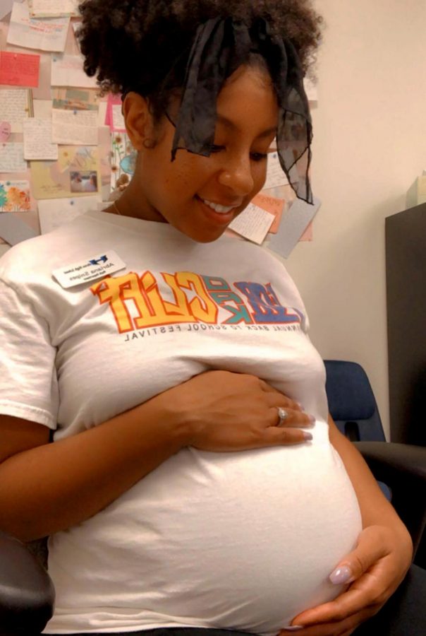 Snipes sits in her classroom on the day she became 33 weeks pregnant. She is currently eight months pregnant. 
