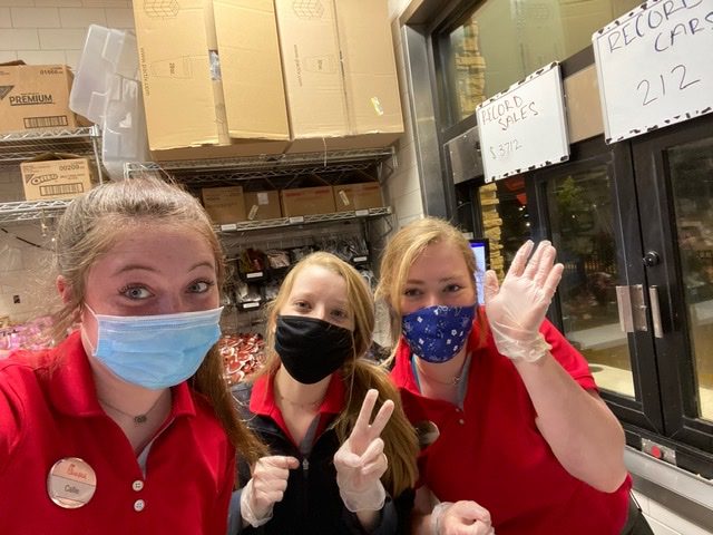 Junior Ellory Liles and two of her coworkers pose together for a photo with their required face masks and gloves. “We are all required to wear face masks and gloves no matter what position we are inside the restaurant,” Liles said.