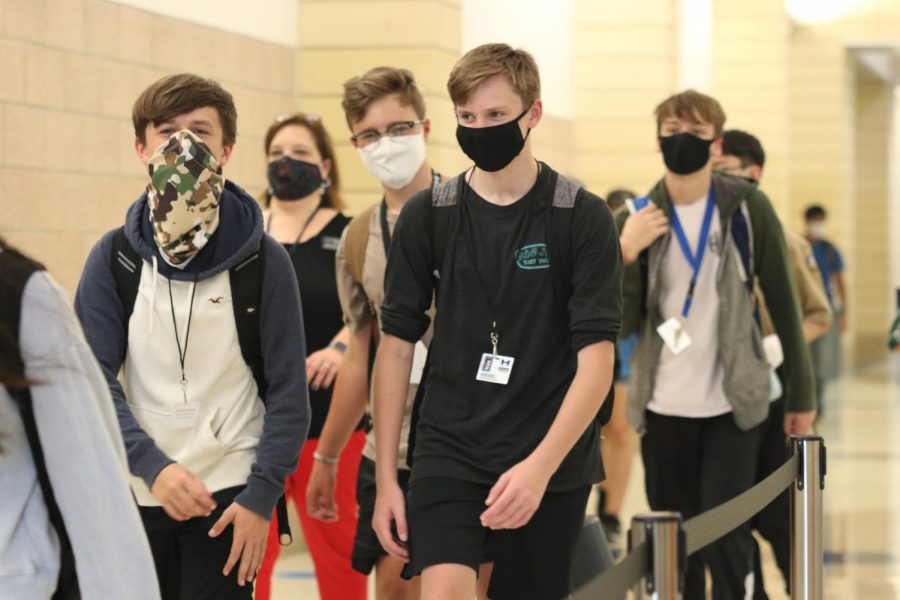 Freshmen Ethan Wait, Alex Schroer and Luke Hines walk to lunch after band class. Students have been following the A, B, C, D lunch schedule to help reduce the number of students in the cafeteria at one given time.  