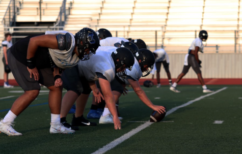 The offensive linemen line up to run through a play at practice on Sept. 16. On Friday, the team will compete against another team for the first time since Nov. 15 in a scrimmage against Allen.