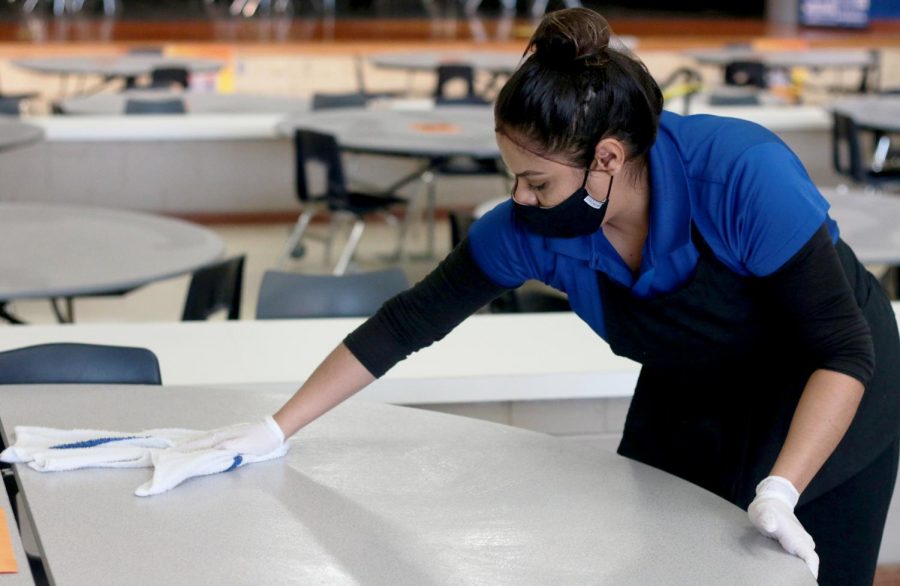 Cafeteria worker Nayely González wipes down cafeteria tables between lunches. Cafeteria workers now conduct much more extensive cleanings, in response to COVID-19. “I was really worried about lunch personally when I envisioned coming back to school,” counselor Dr. Justin Fields said. “My initial thoughts have been good.”