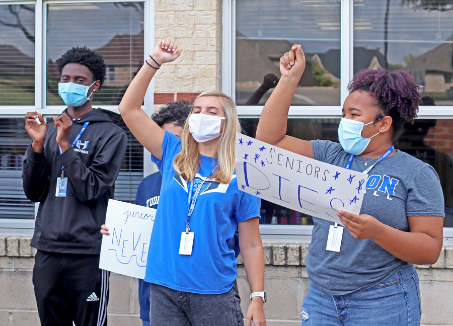 Student Council seniors Dexter Mitchell, Sydney Stafford and Tamia Hatcher shout for a video of the “Hawk Pride Never Dies” chant. The video will be a clip in the virtual homecoming pep rally to be held on Nov. 13.