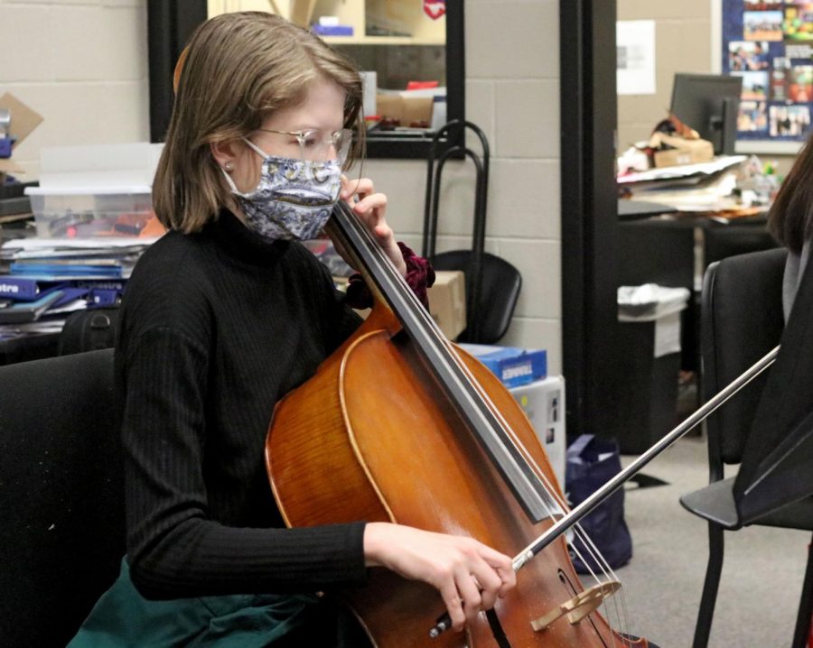 Senior Marianna Rooks plays the cello during orchestra practice. Many of the concerts, such as the cluster concert with the middle schools, have been cancelled due to COVID-19 restrictions.