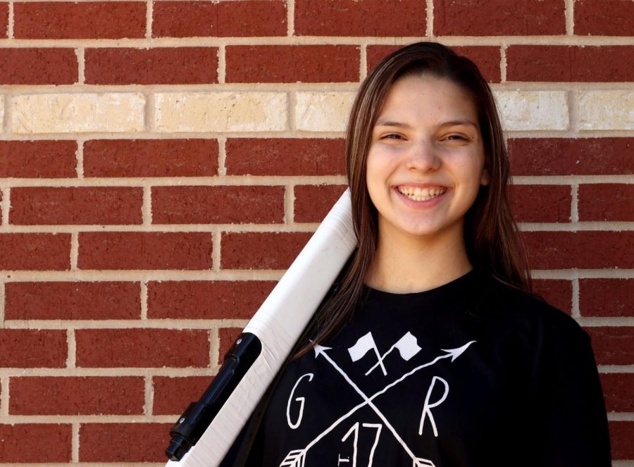 Senior Anabel Sanchez stands outside the gym with her rifle. As one of the color guard captains, Sanchez has had to adapt to her role as a leader due to COVID. “It’s been difficult to adjust with covid rules, but just being around my team is what makes my experience better,” Sanchez said.