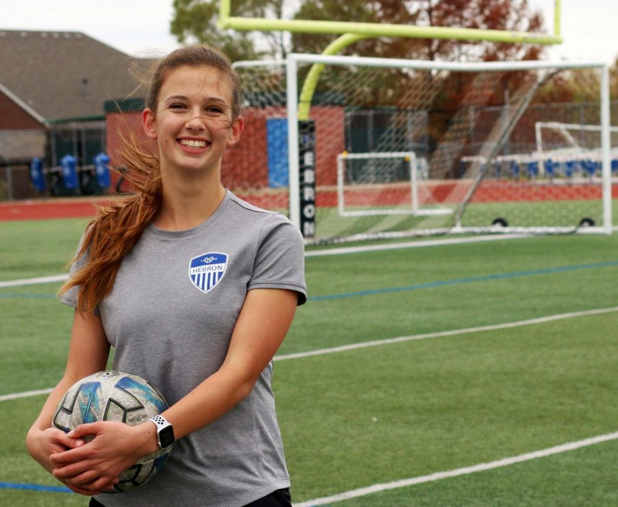 Junior Sydney Japic stands with a ball on the soccer field after practice. Sydney was unable to play high school soccer the past two years. “I’m looking forward to starting to play high school games because I’ve never played high school soccer before,” Japic said. “This is my first year.”