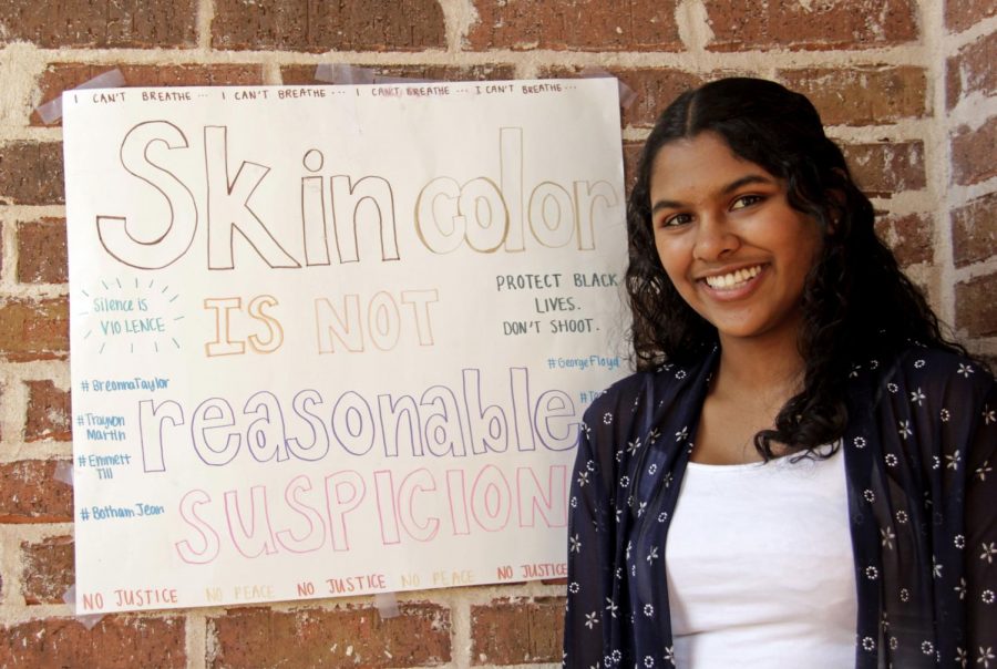 Junior Nandita Kumar poses next to a homemade sign expressing her personal beliefs about the anti-racism movement. Kumar is an adamant supporter of the movement and takes active efforts to fight racial injustice in her community through her position in March For Our Lives (MFOL), a youth-led gun violence prevention organization.