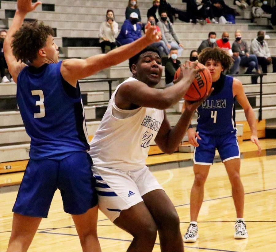 Junior Noah Mckinney plays strong basketball in the paint, moving defenders out of his way. Mckinney had five rebounds, asserting his dominance as a center. 