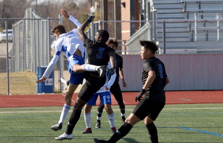 Senior centre back Cayden Casburn collides with a Tyler player during a corner kick. Casburn is one of the team captains and this is his second year on varsity.