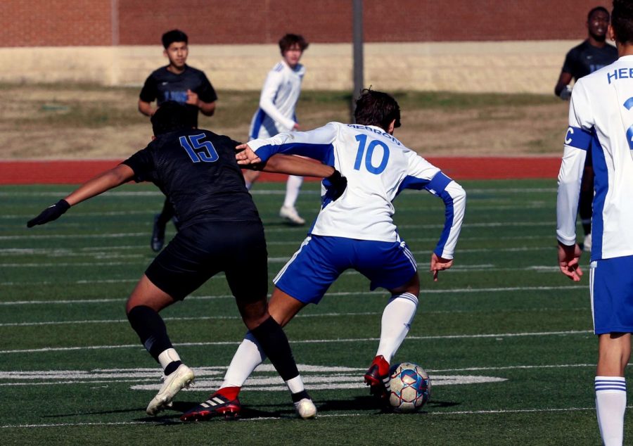 Senior Garrison Hatley pushes a Tyler player away in order to maintain control of the ball. Hatley has been named one of the team’s captains for the 2020-21 season. 