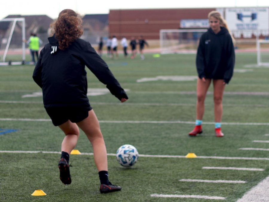 Juniors Rylan Rolich and Weslyn Brown work on passing drills at Wednesday practice. Girls soccer has completed preseason and is going into district play with five wins and one loss.