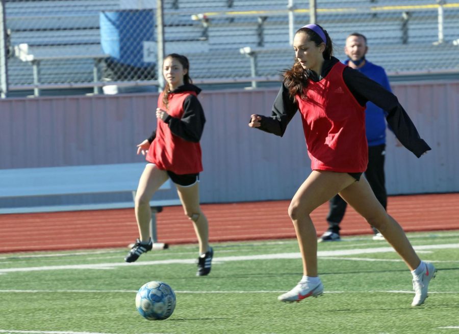 Senior Matilda Torres runs with the ball toward the goal during practice on Feb. 4. The team was divided into two groups and had scrimmages to practice their techniques.