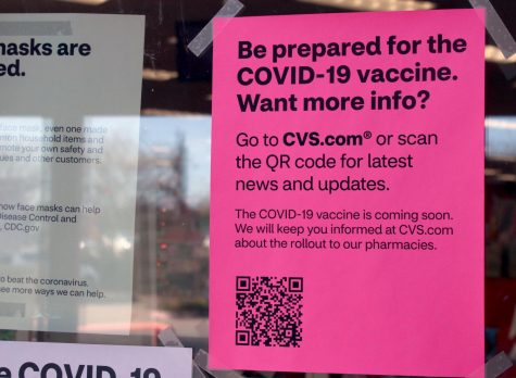 A sign with information on COVID-19 vaccines is taped onto the door of CVS Pharmacy on Josey and Hebron. There are currently multiple eligible groups for the vaccination within four different phases: healthcare workers, long-term care facility residents, frontline essential workers, people over the age of 16 with pre-existing conditions and more.
