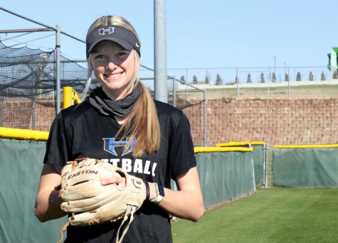 Senior Riley Nicholson poses outside the softball field with her glove. Nicholson has been playing softball for the last 8 years and has committed to play in college too.
