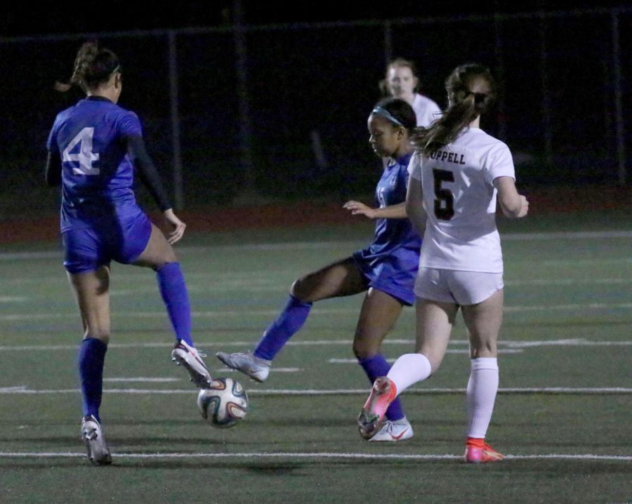 Sophomore forward Aryanna Jiminson and senior forward Taylor Cheatham pass the ball to each other during their game against Coppell. The team is currently ranked fourth in the district.
