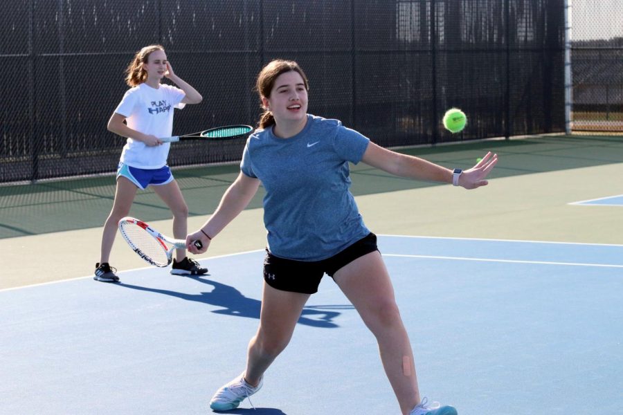 Freshman Macie Snyder hits a forehand return during practice. Snyders doubles partner is junior Abby Lux and they have placed in multiple tournaments.